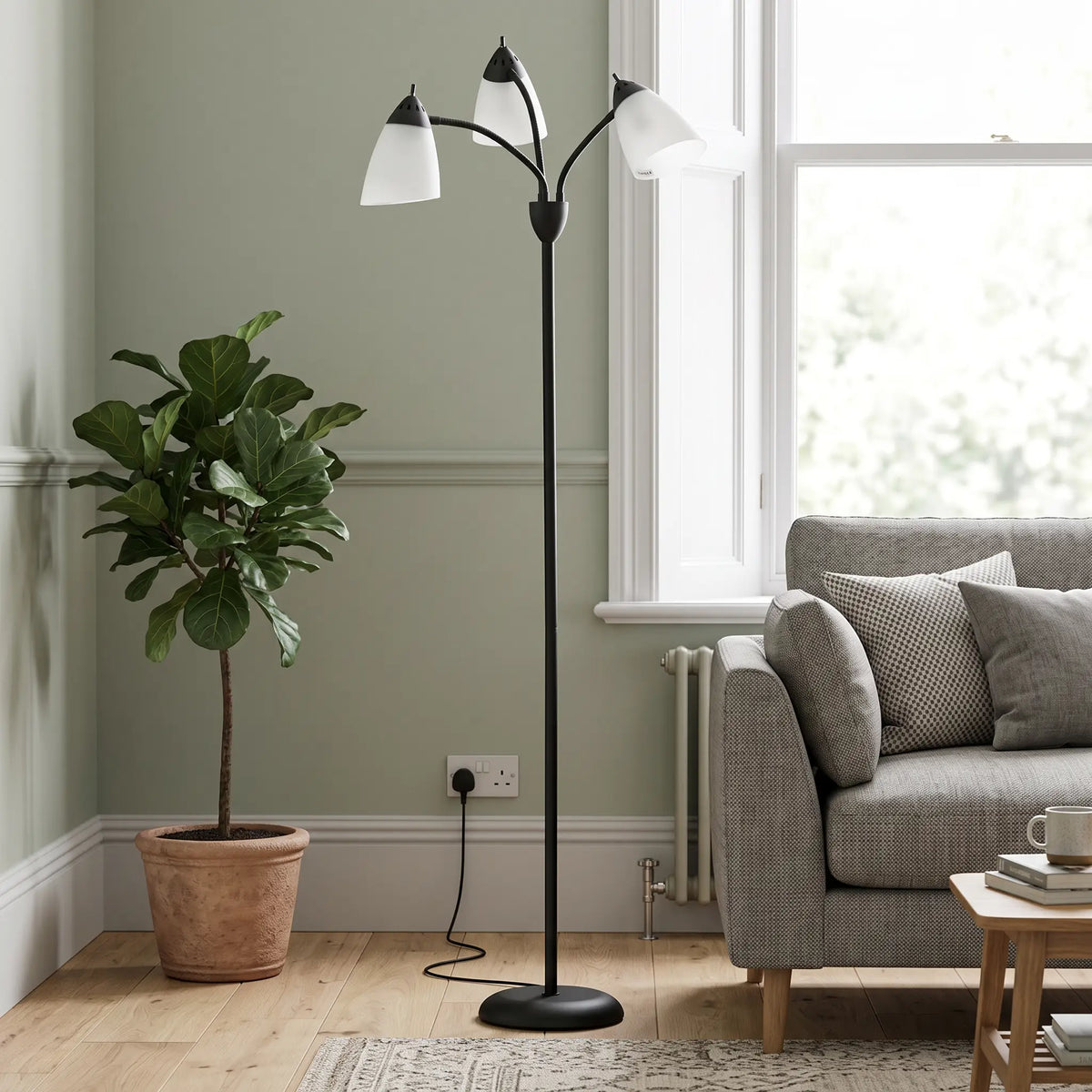 Black 3-light tree floor lamp in a living room in daylight