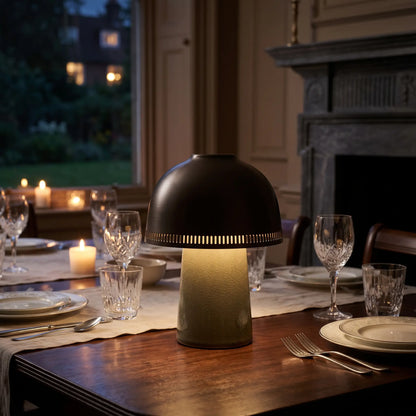 Sage green ceramic lamp with copper shade on a dinner table