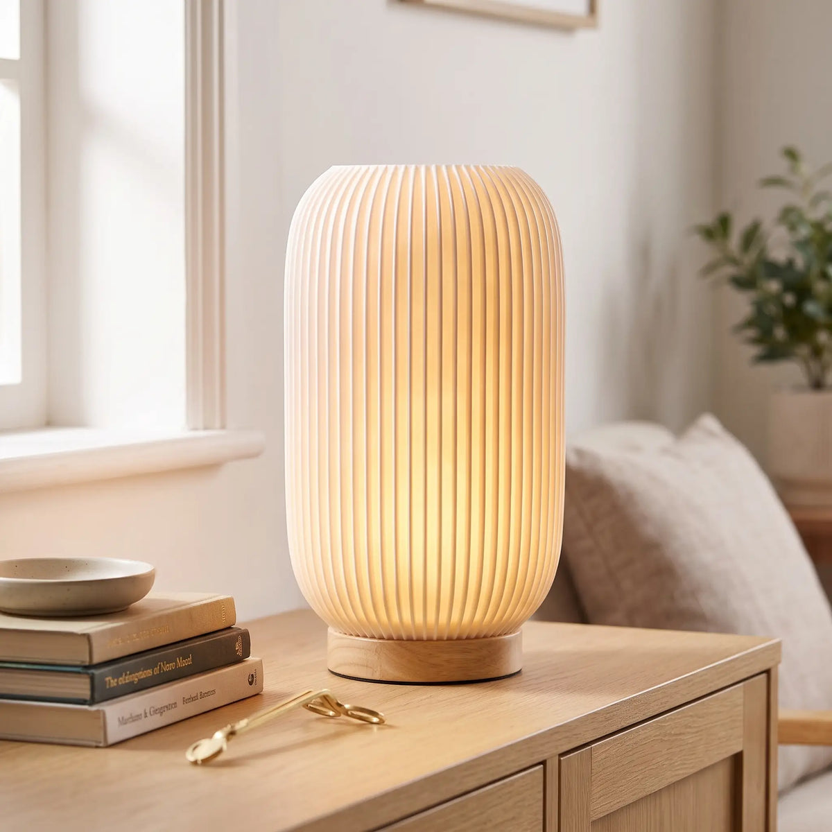 Linear ribbed table lamp with wooden base on an oak sideboard