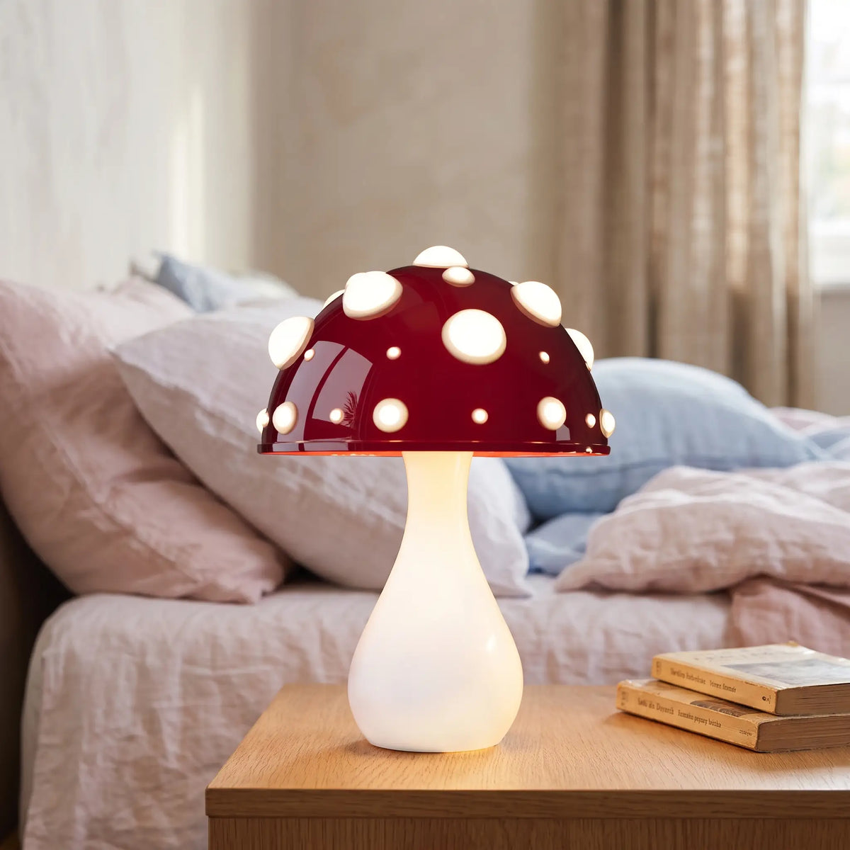 Red toadstool mushroom lamp with white stem on a bedside table