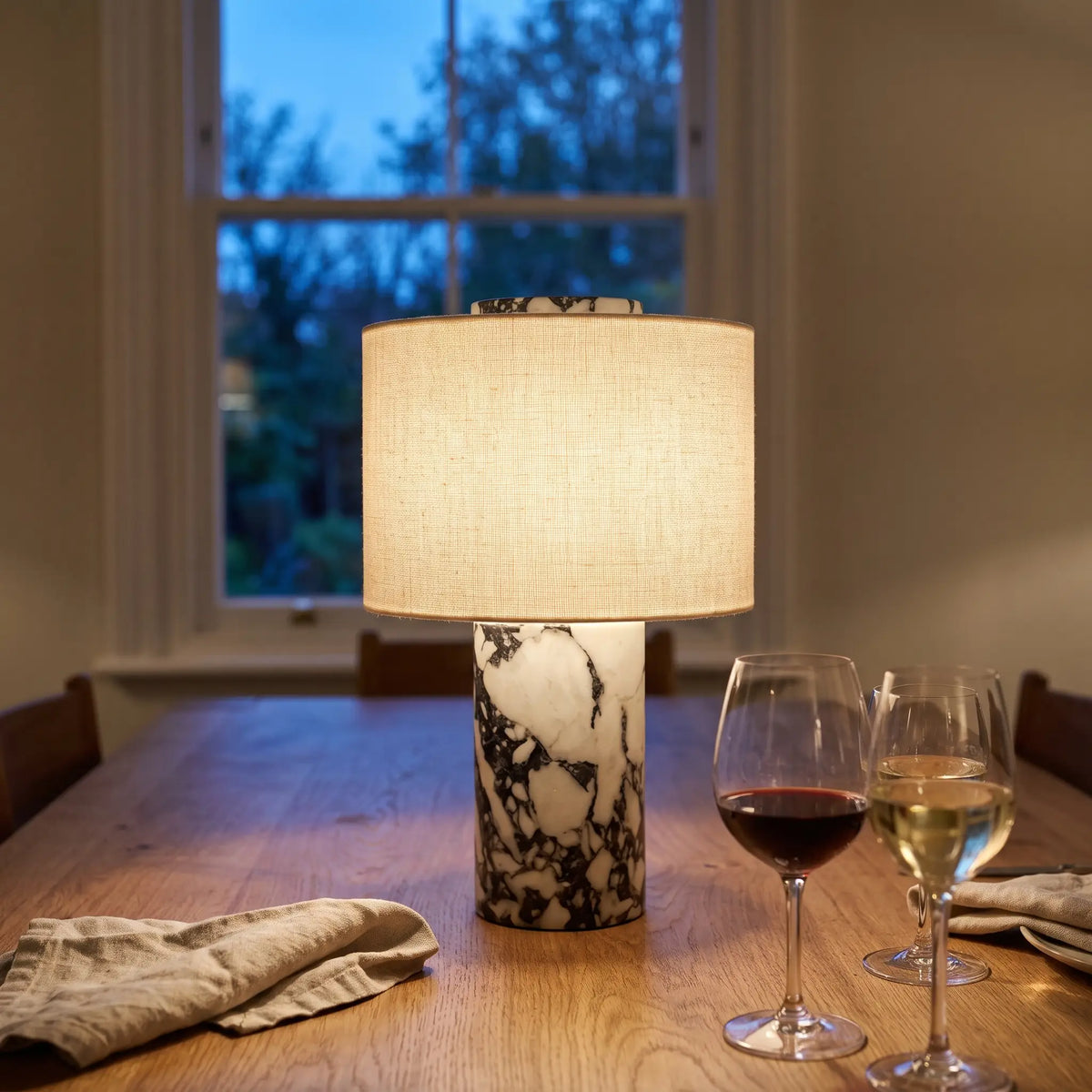 Cordless marble table lamp on a dining table at dusk