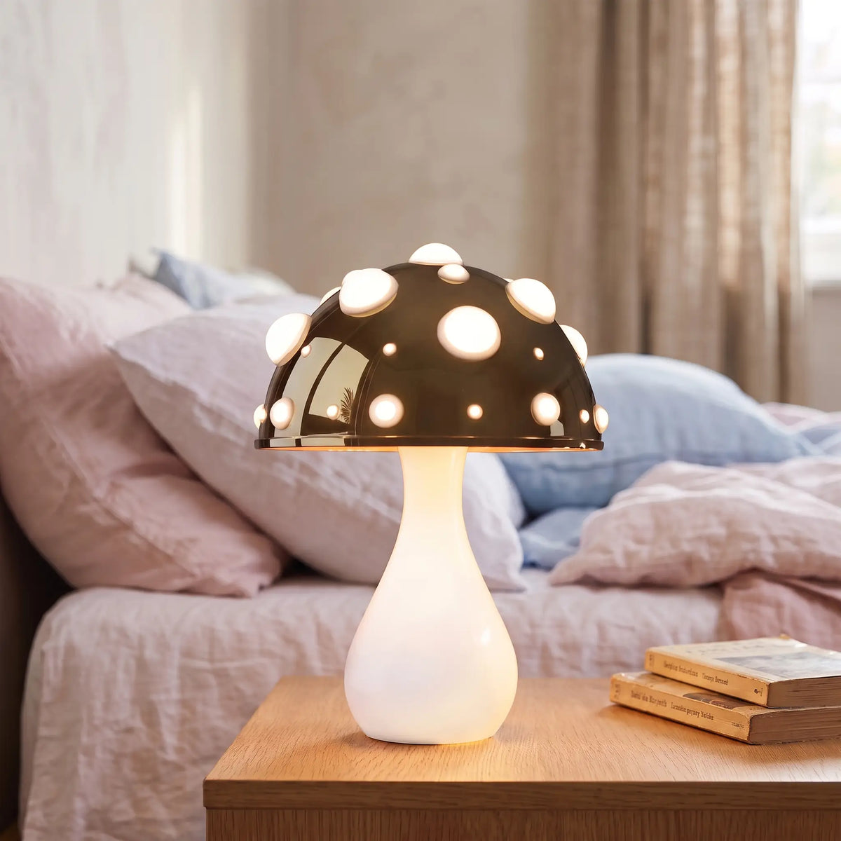 Dark gold toadstool mushroom lamp with white stem on a bedside table