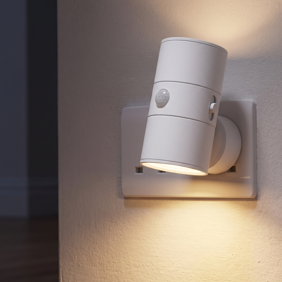 White plug-in motion sensor night light in a UK socket