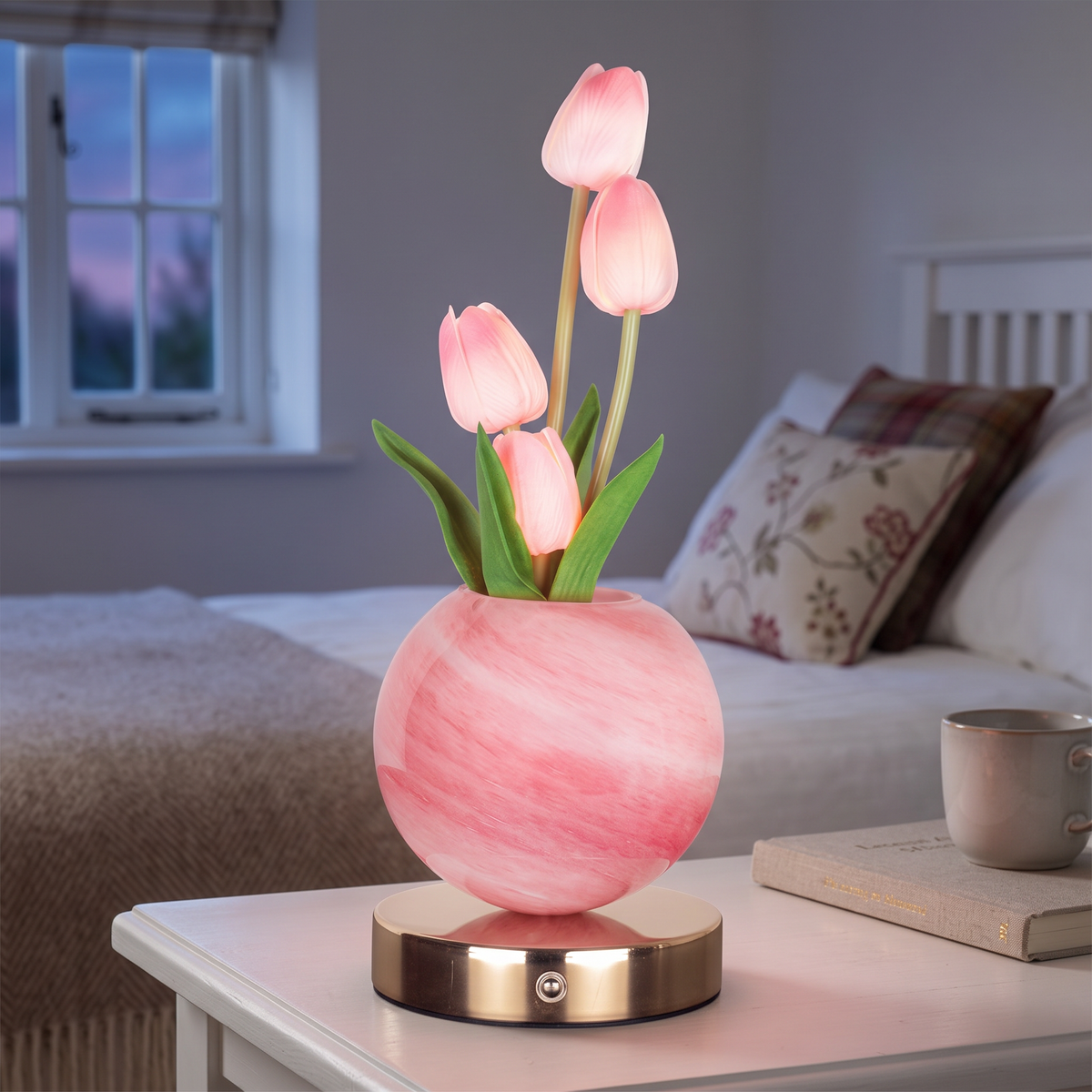 Glass tulip lamp with pink tulips on a bedside table