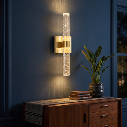 Crystal-effect wall light glowing on a dark blue living room wall