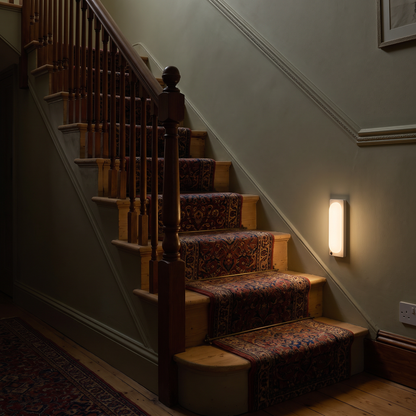 Rechargeable motion sensor light beside a staircase