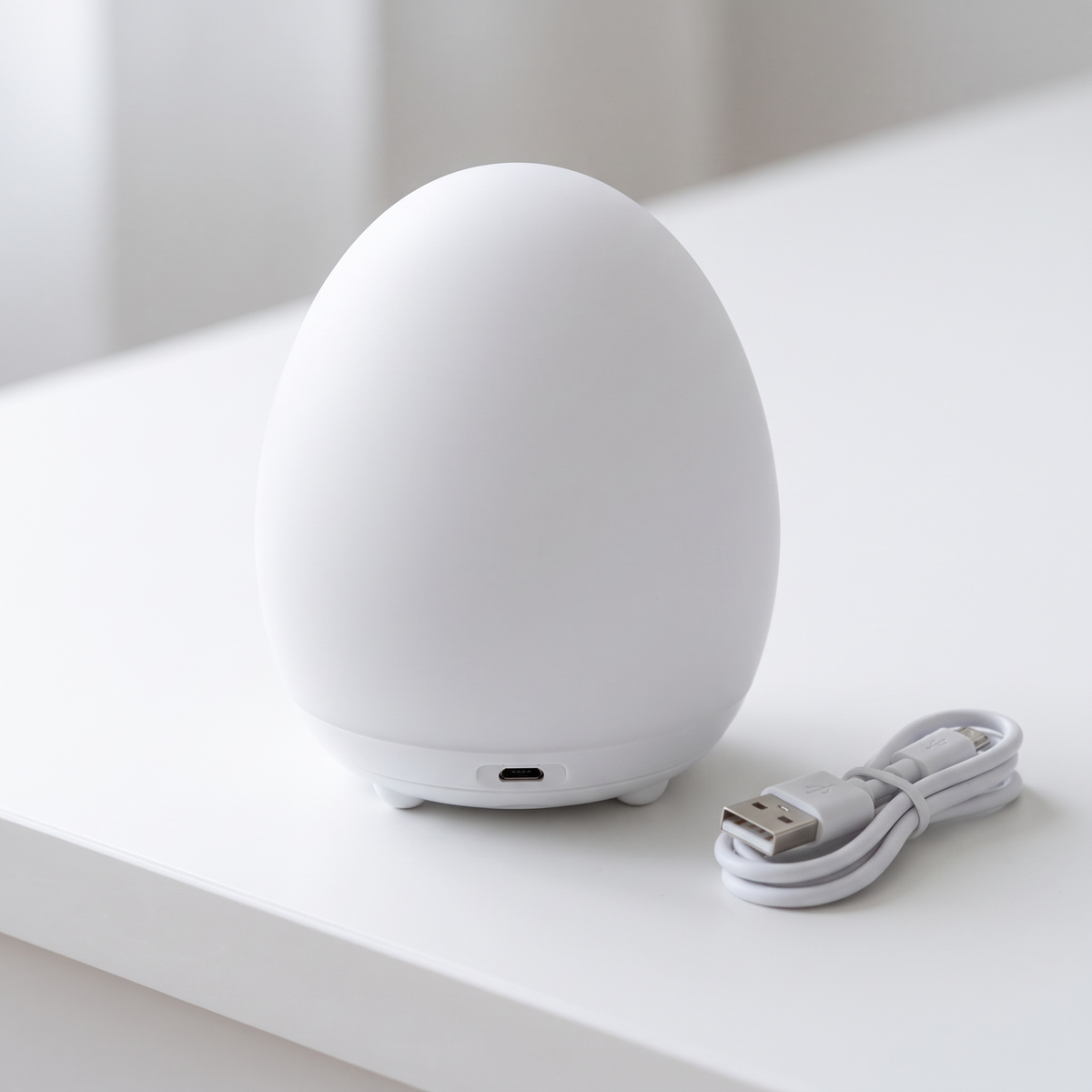 Egg night light close-up with USB charging port and cable