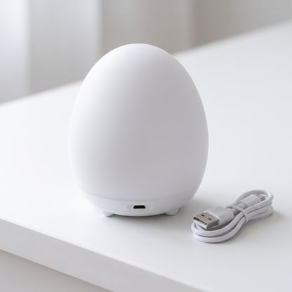 Egg night light close-up with USB charging port and cable