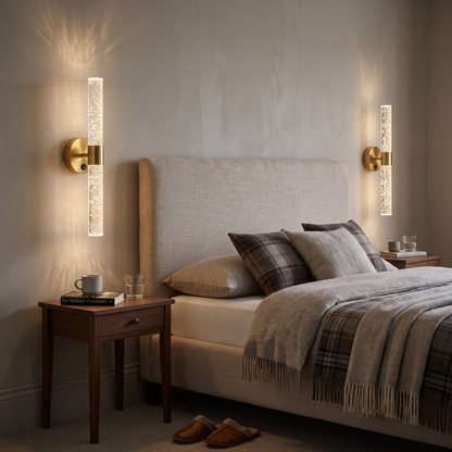 Pair of round gold crystal-effect wall lights either side of a bed