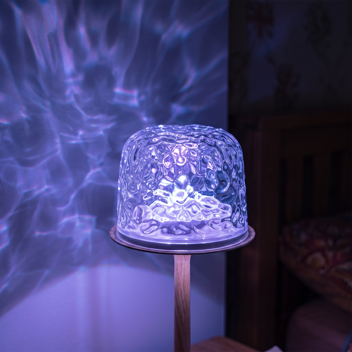 Close-up of the textured ripple lamp shade glowing violet and blue